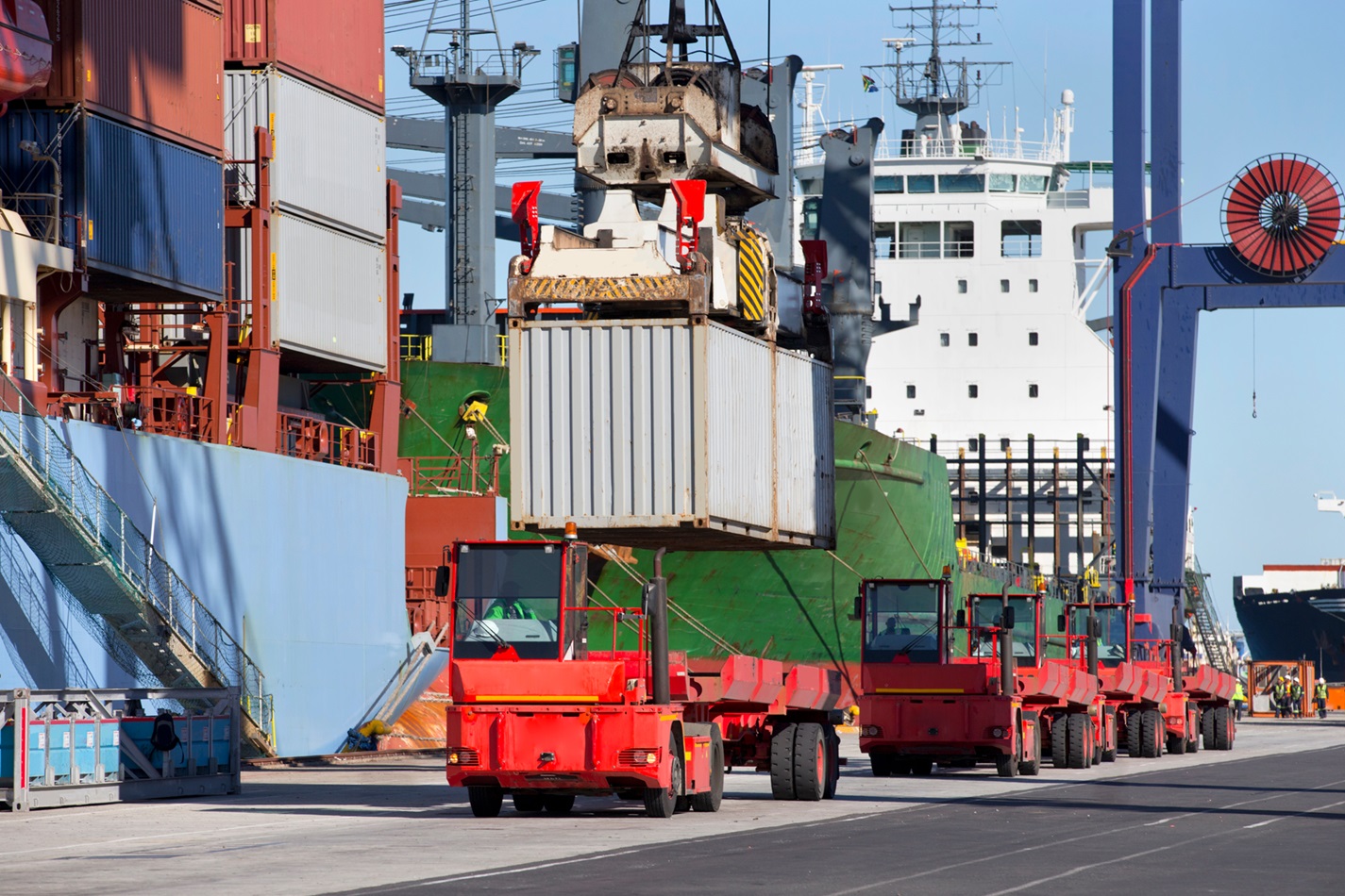 //vetstb.com/wp-content/uploads/2026/07/a-crane-loading-cargo-containers-on-a-truck-at-a-c-2026-03-26-09-00-03-utc-1.jpg