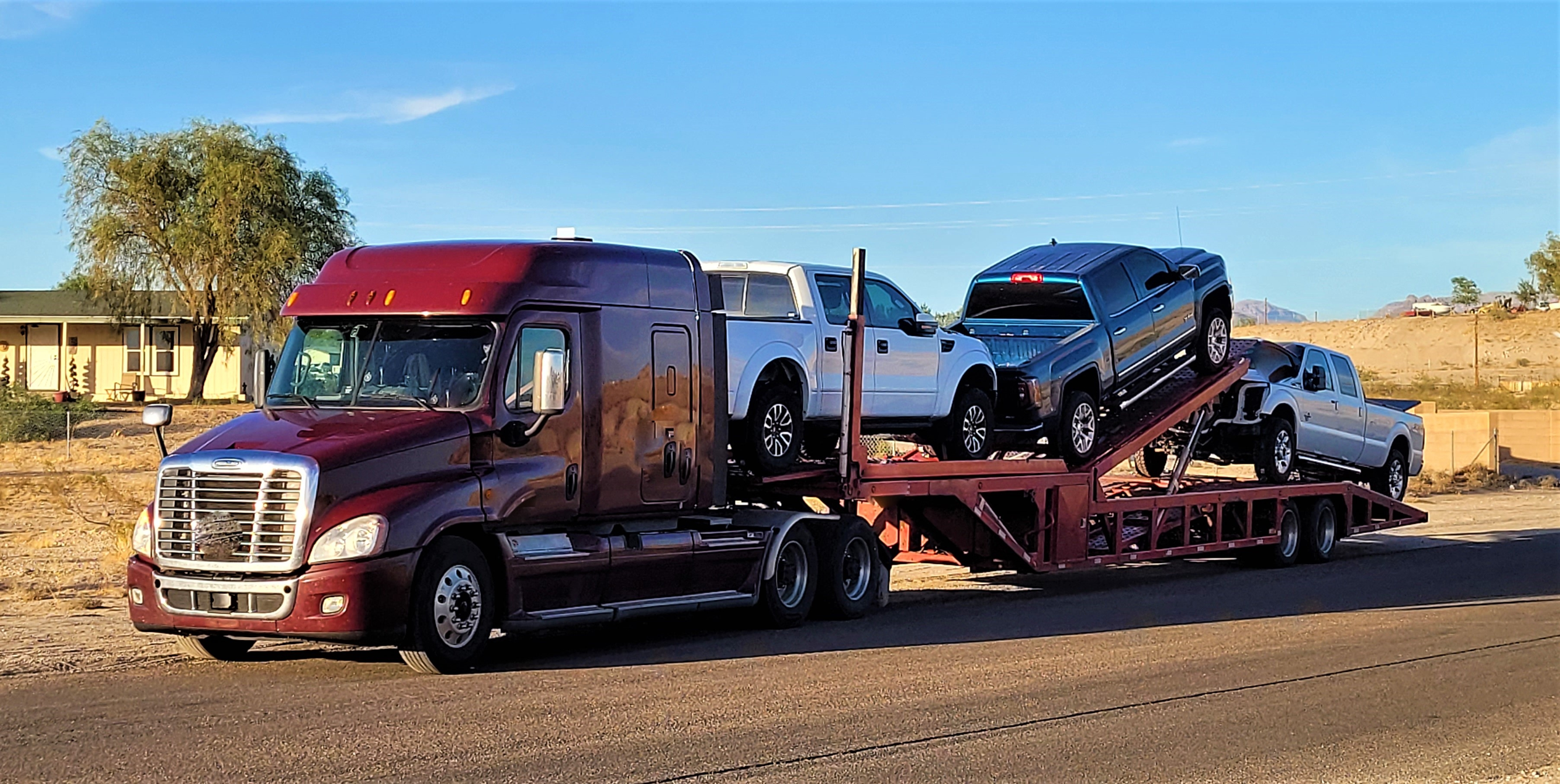 //vetstb.com/wp-content/uploads/2026/08/truck-transporting-pickups-across-desert-landscape-2026-07-15-21-36-01-utc-1.png